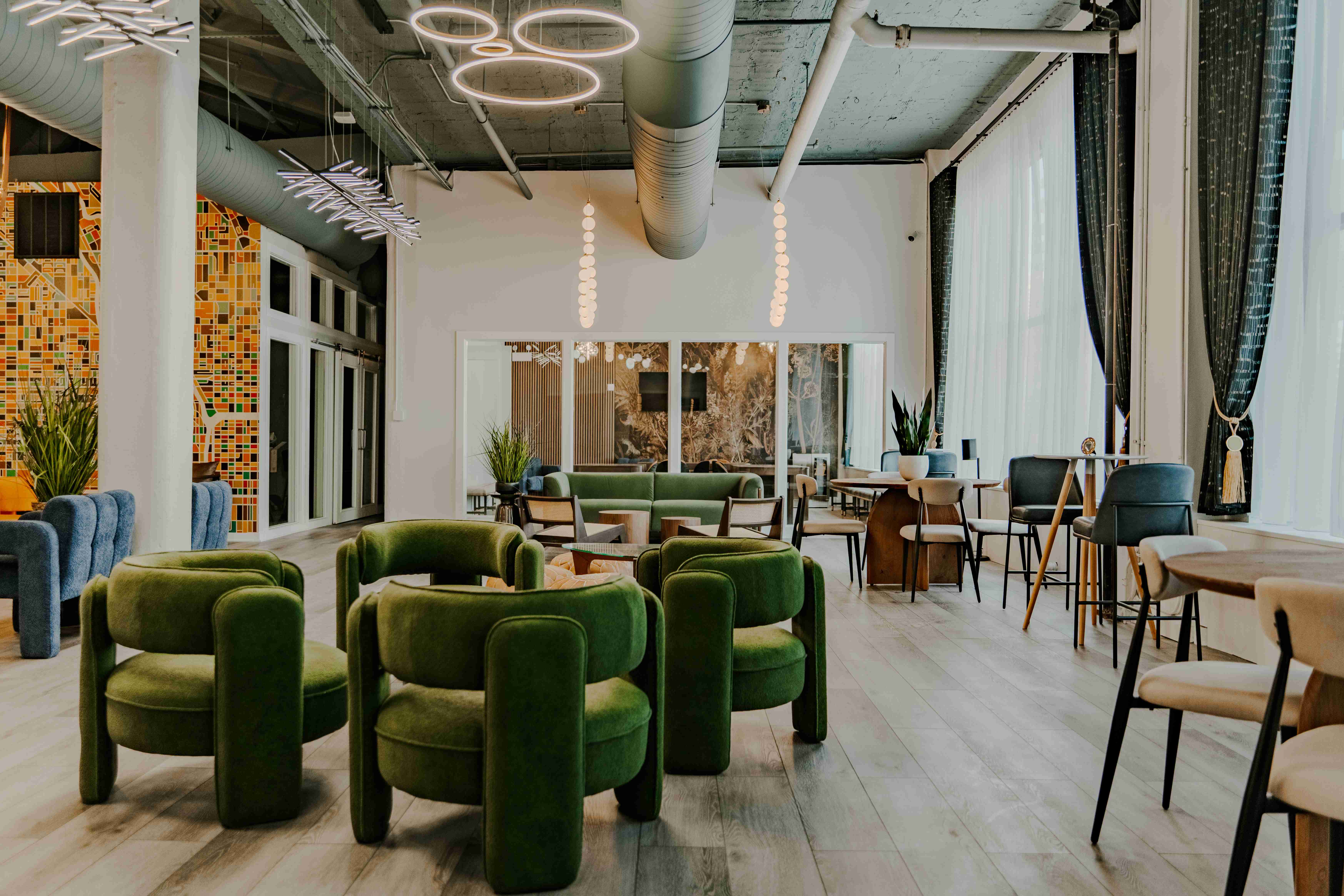 Three Cities Social clubhouse interior with green velvet chairs and modern design