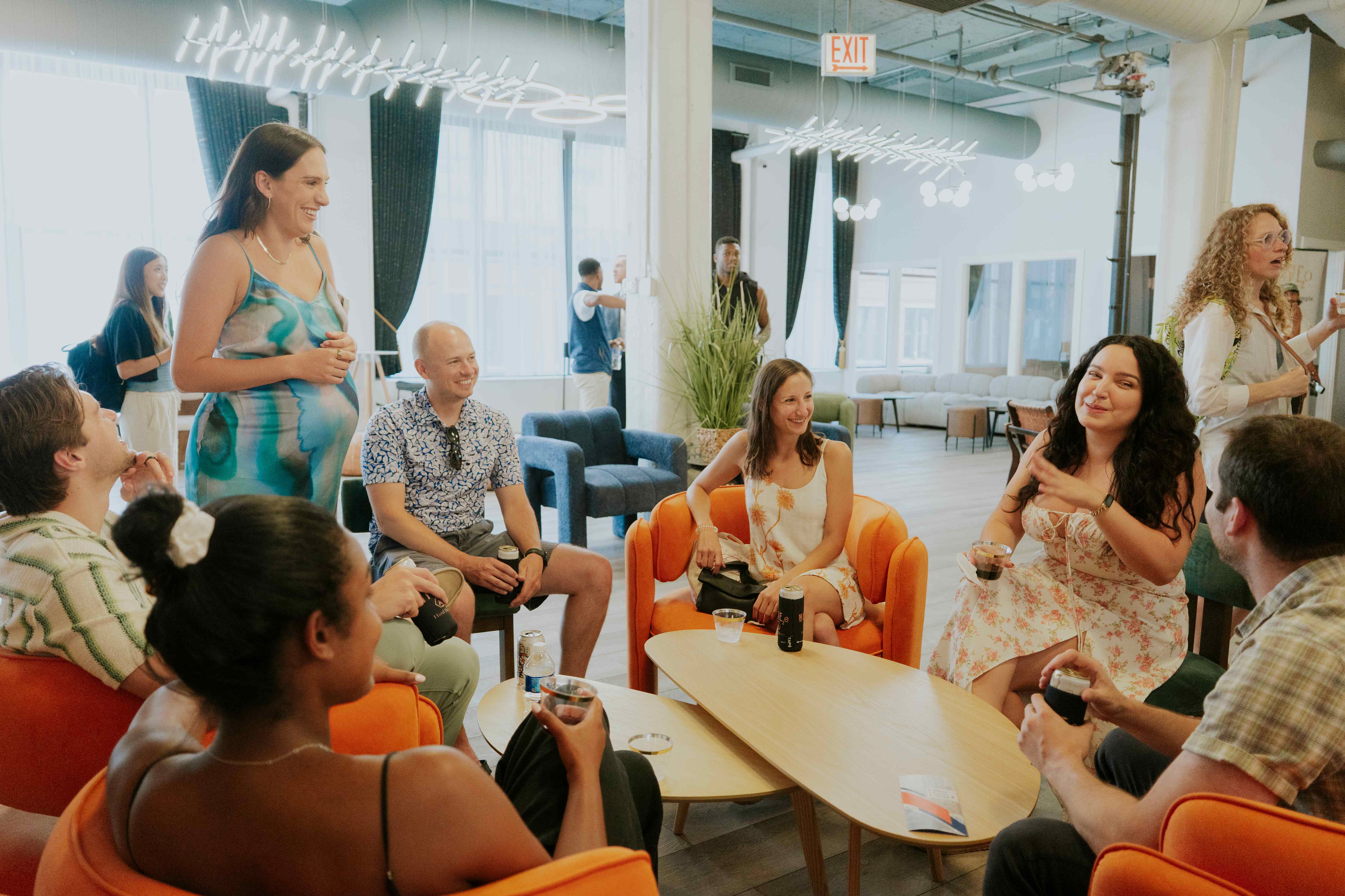 Members socializing and connecting in the Three Cities Social clubhouse lounge area