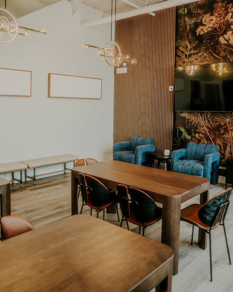 Workspace and dining area with mixed seating and plant wall