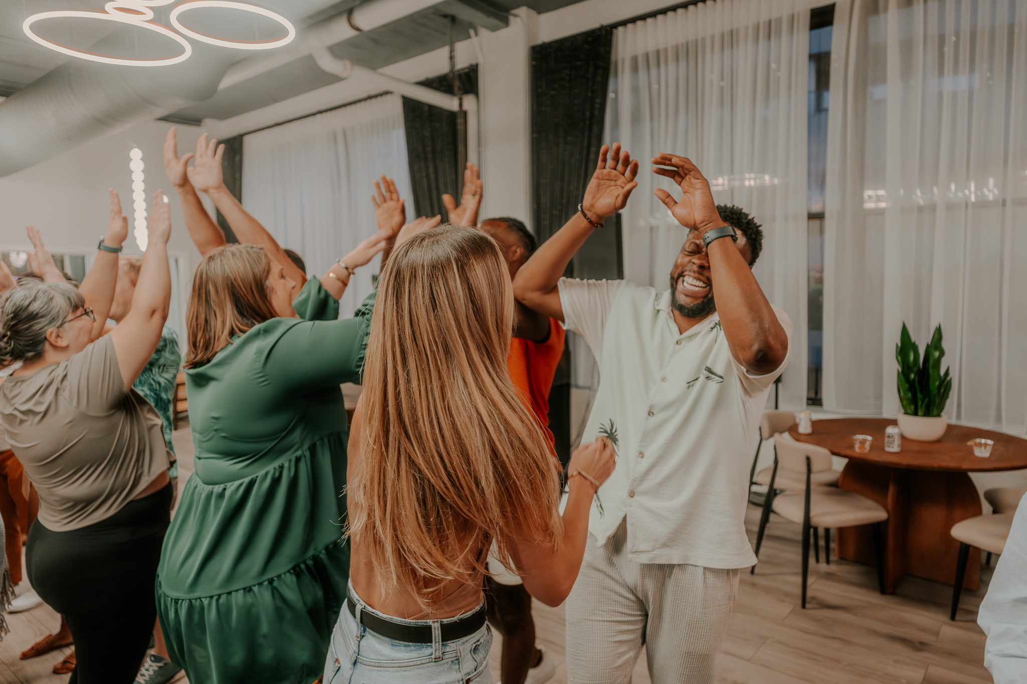 Members celebrating and participating in a joyful group activity at Three Cities Social